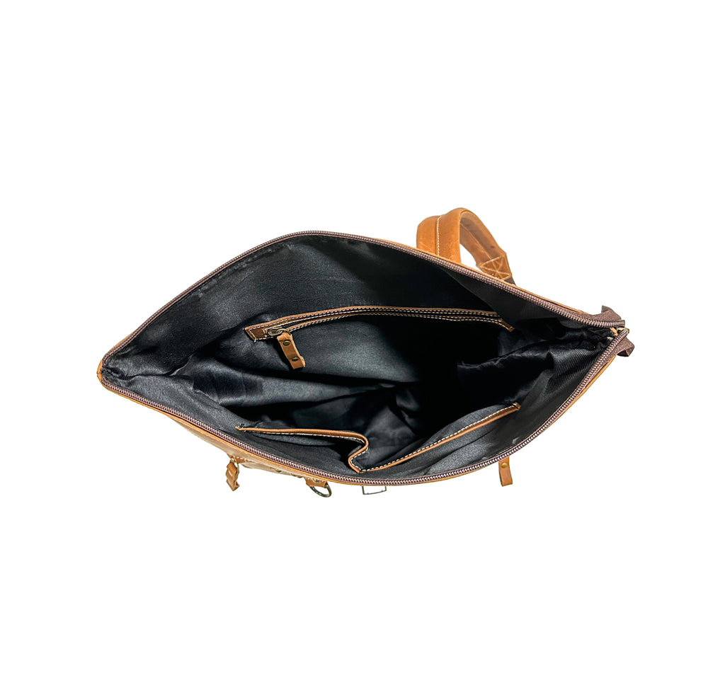Open black leather bag with tan interior and trim on a white background
